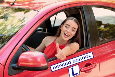 Image of Happy young woman in car. Visiting driving school