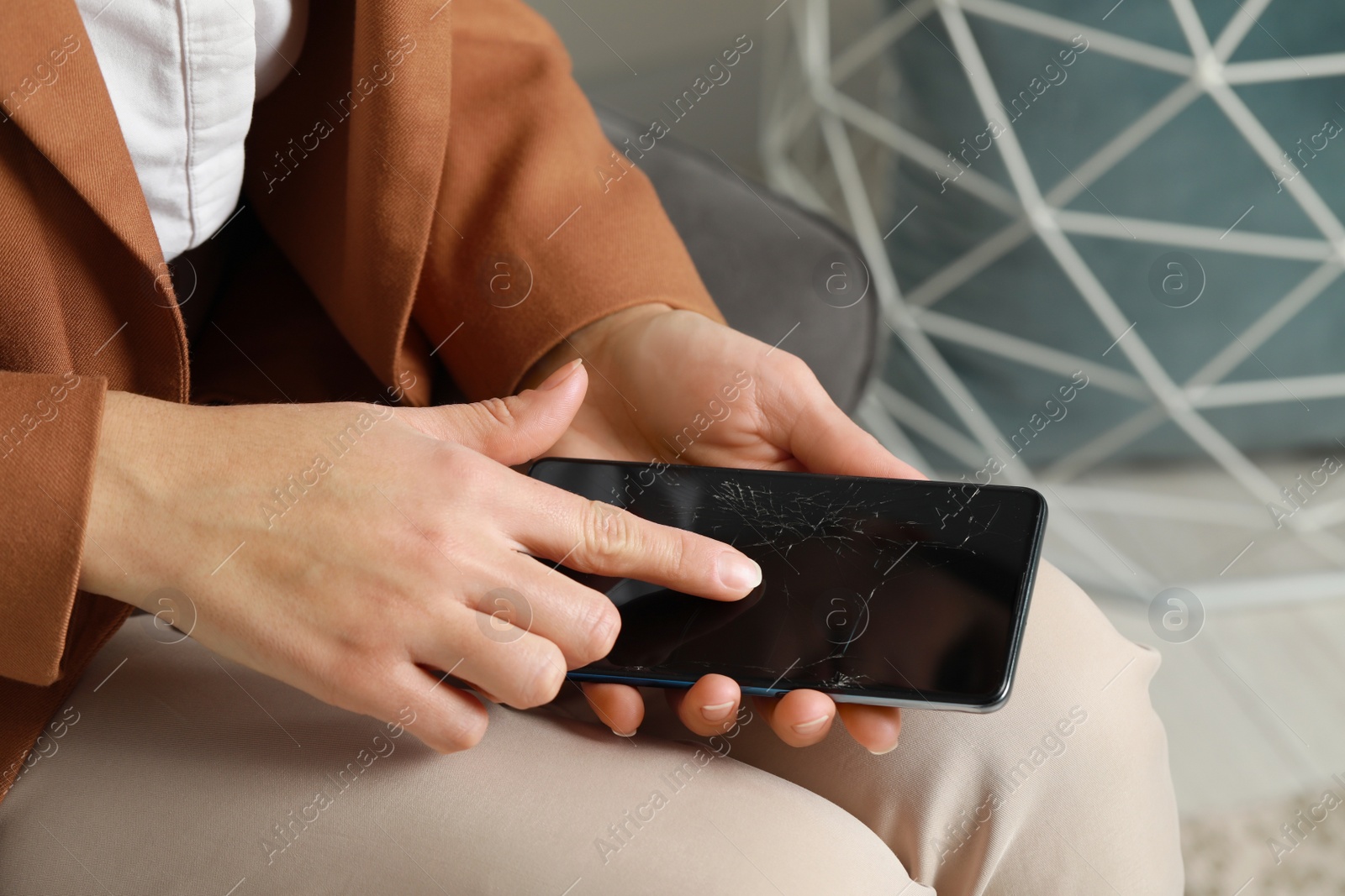 Photo of Woman with damaged smartphone indoors, closeup. Device repairing