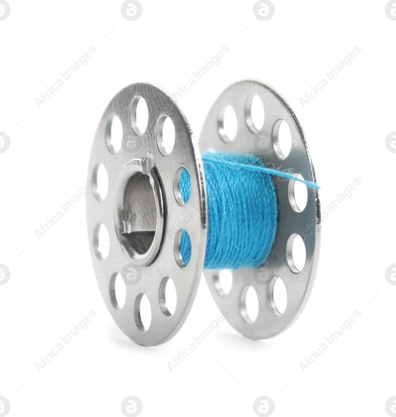 Photo of Metal spool of light blue sewing thread isolated on white