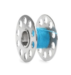 Photo of Metal spool of light blue sewing thread isolated on white