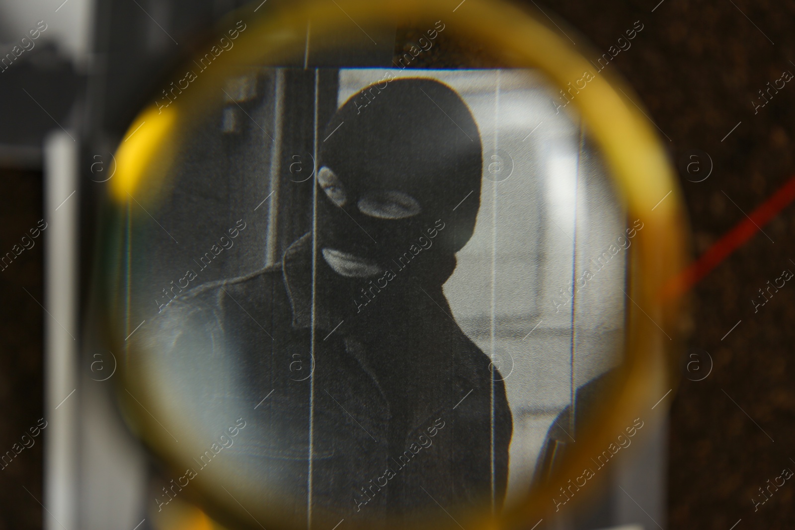 Photo of Looking at detective board through magnifying glass, closeup