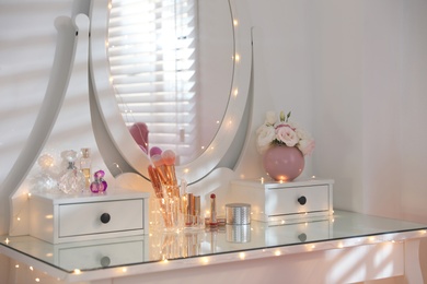 Elegant dressing table with lights in stylish room interior