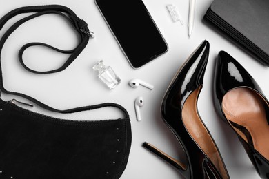 Photo of Flat lay composition with stylish woman's bag on light background