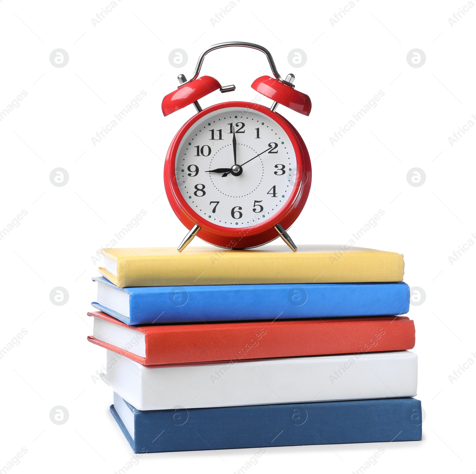 Photo of Red alarm clock and different books on white background. School time