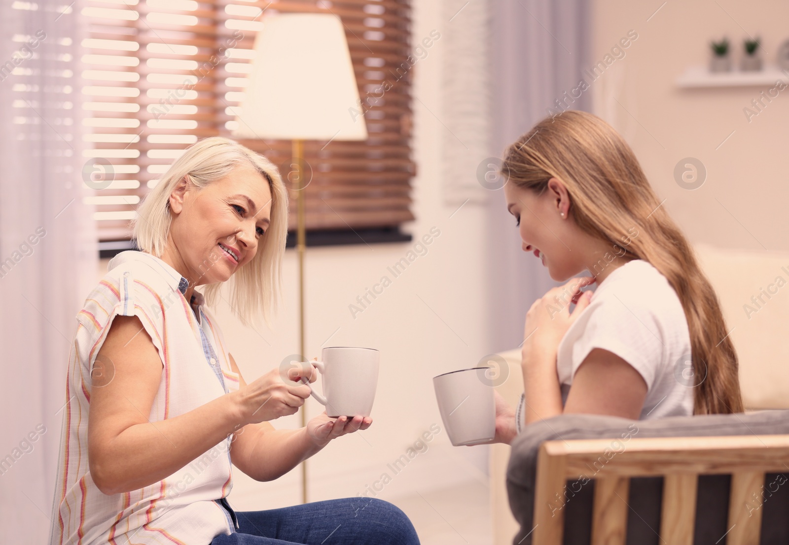 Photo of Mother and her adult daughter spending time together at home