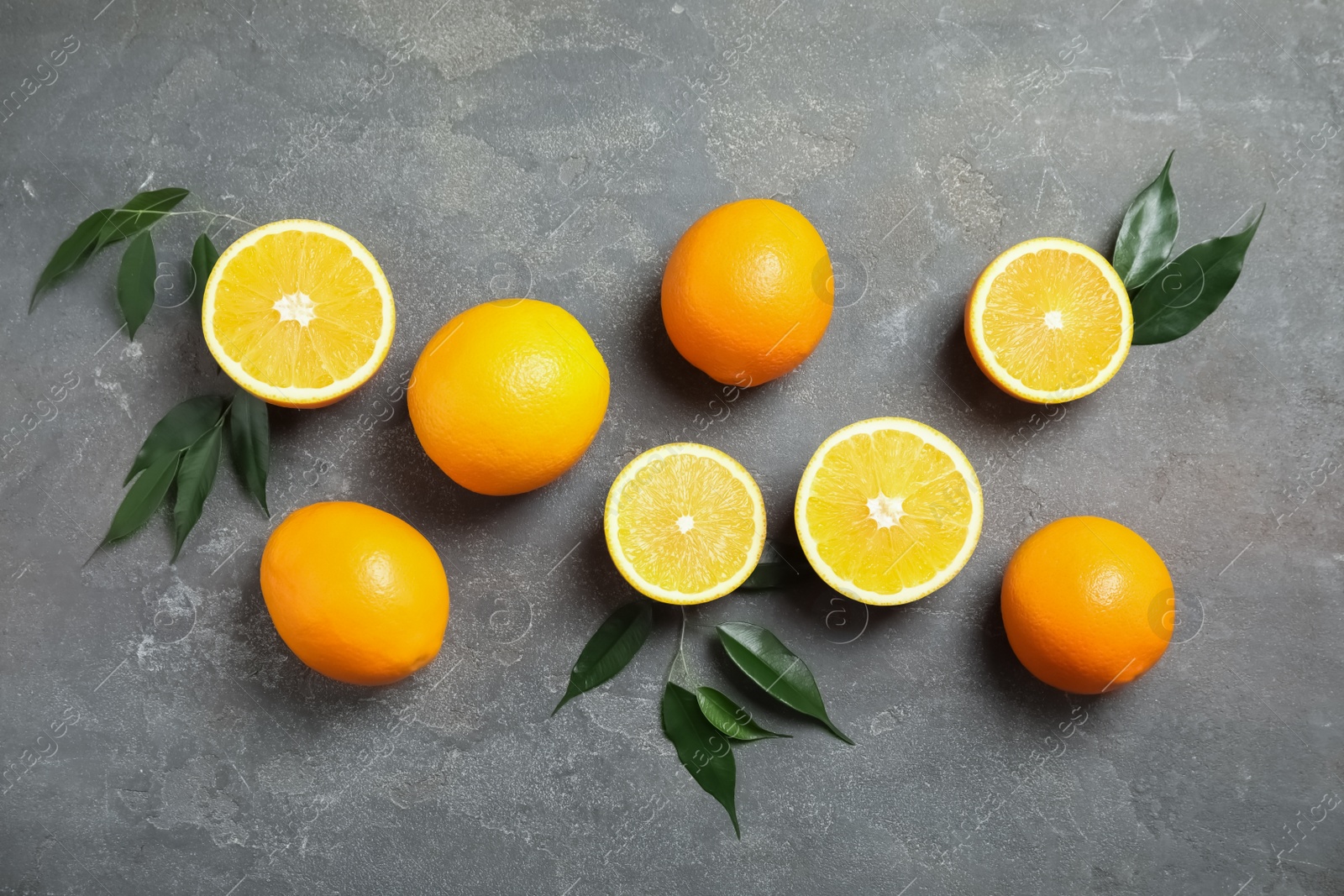 Photo of Flat lay composition with fresh oranges on grey background