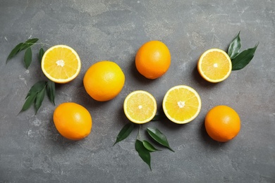 Flat lay composition with fresh oranges on grey background