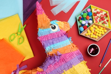 Photo of Flat lay composition with cardboard donkey on red background. Pinata diy