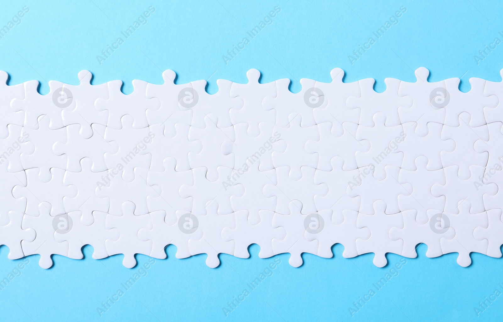 Photo of Blank white puzzle light blue background, top view