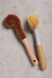 Photo of Cleaning brushes on light grey table, top view