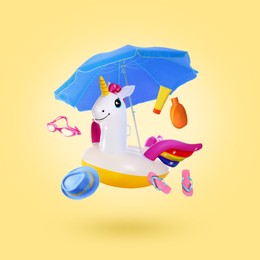 Image of Sunscreen and beach accessories flying on pale yellow background