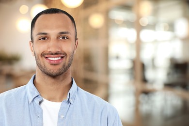 Image of Portrait of handsome confident man in office, space for text