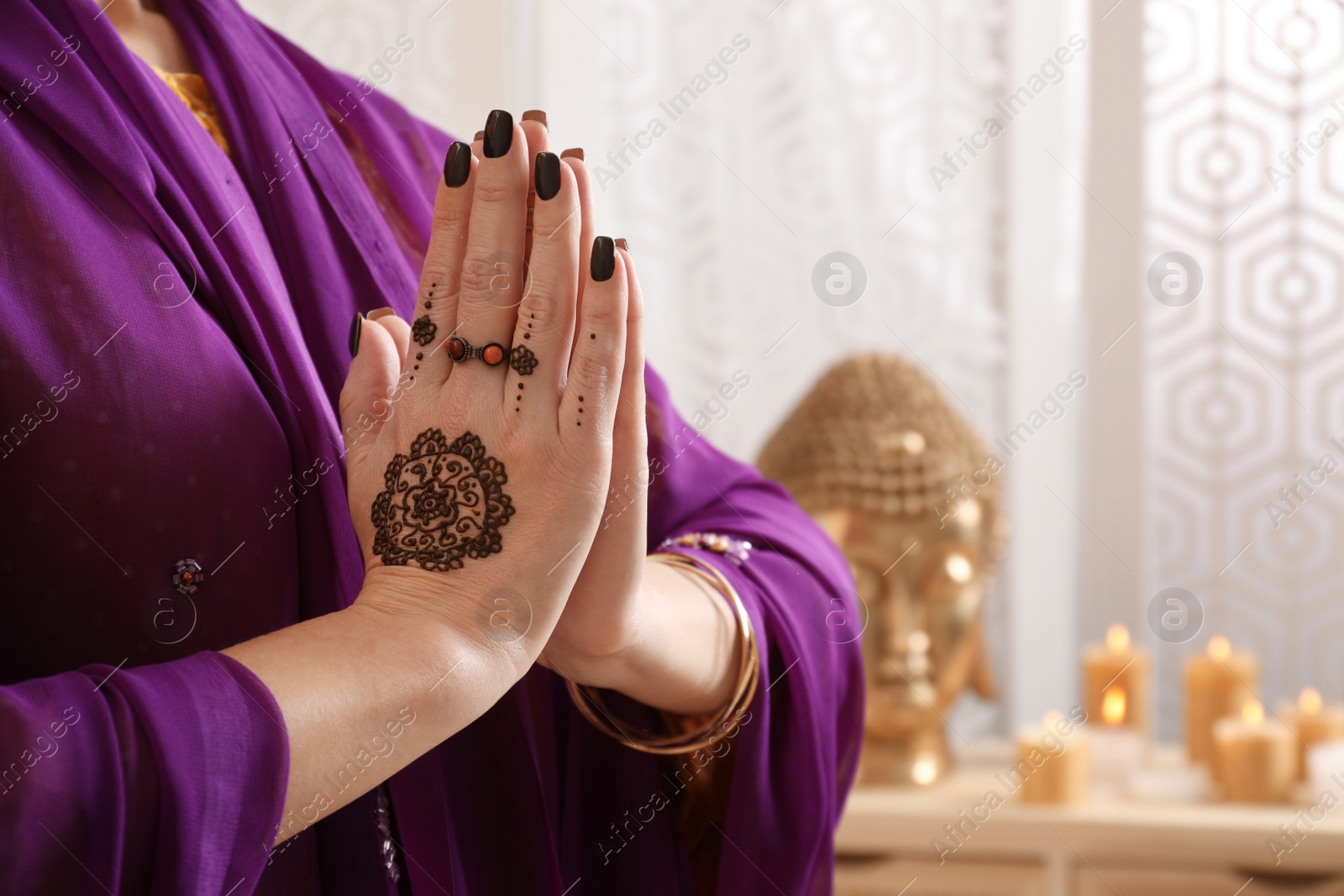 Photo of Woman with henna tattoos on hands indoors, closeup and space for text. Traditional mehndi ornament