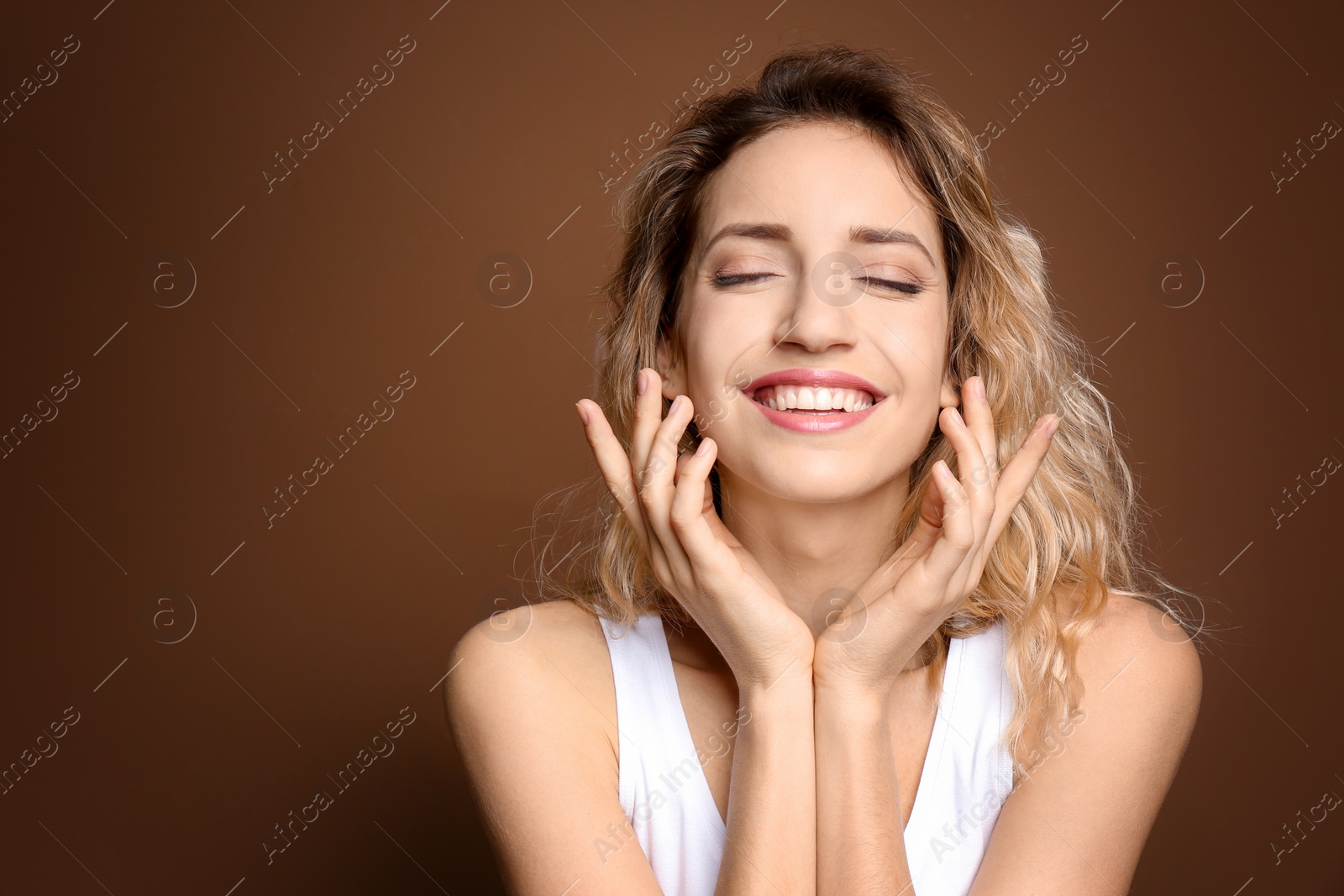 Photo of Young woman with beautiful smile on color background. Teeth whitening