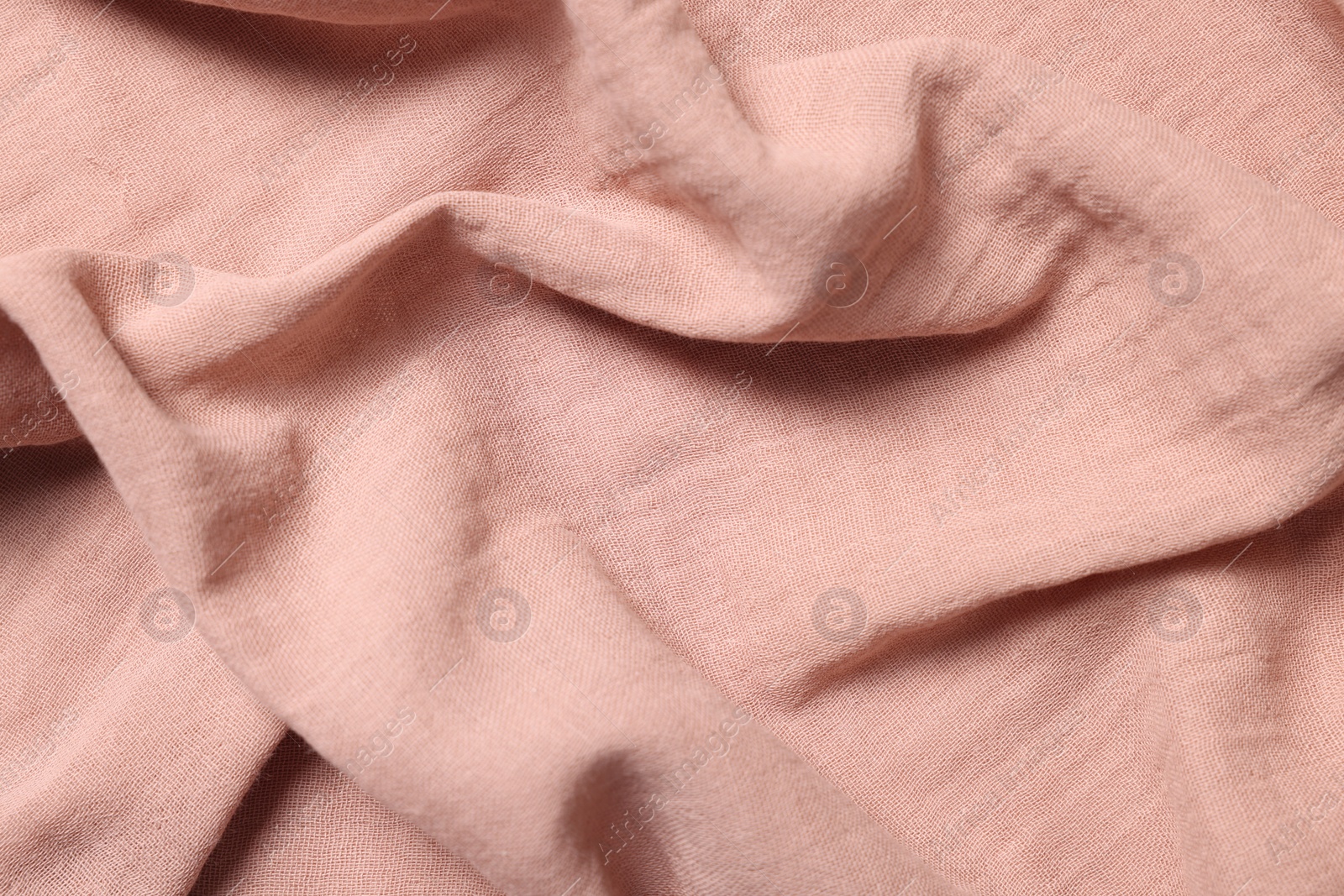 Photo of Texture of soft pastel crumpled fabric as background, top view