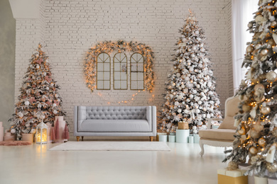 Photo of Beautiful interior of living room with decorated Christmas trees