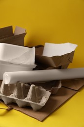 Photo of Heap of waste paper on yellow background
