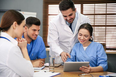 Team of professional doctors having meeting in office