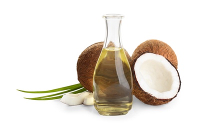 Photo of Ripe coconuts and bottle with natural organic oil on white background