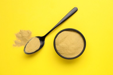 Photo of Beer yeast powder on yellow background, flat lay