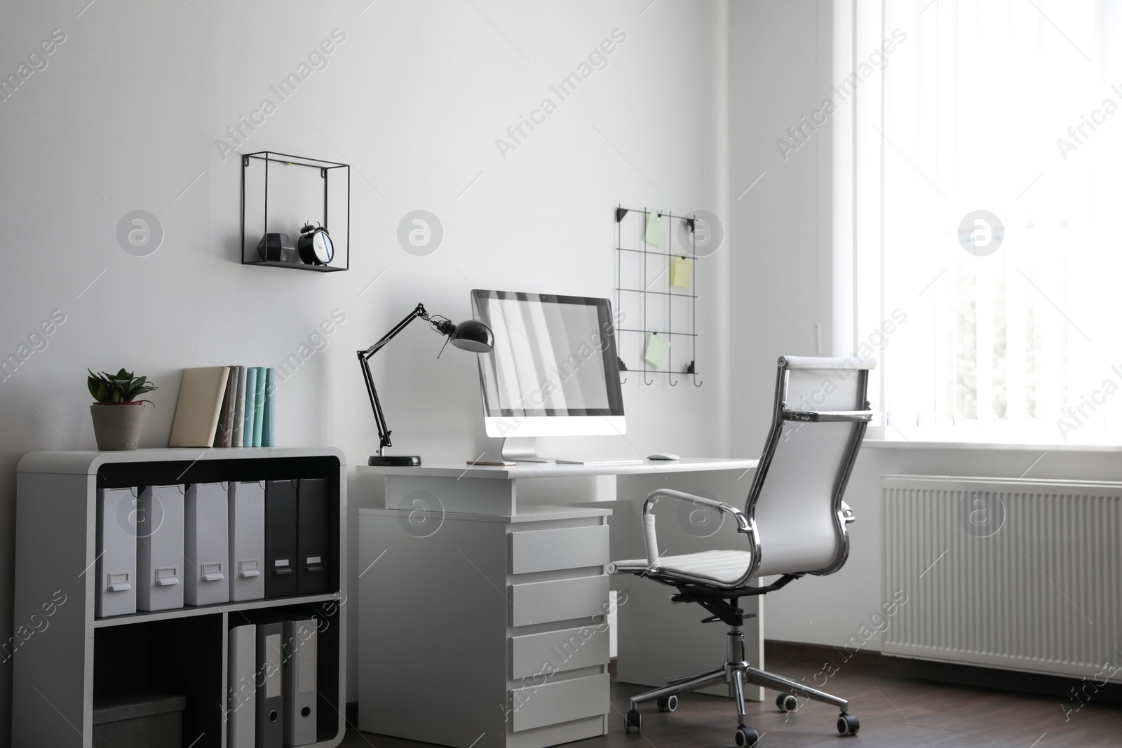 Photo of Comfortable white chair near desk in stylish office interior