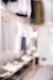 Photo of Blurred view of modern dressing room with stylish clothes