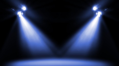 Image of Bright spotlights in darkness. Professional stage equipment