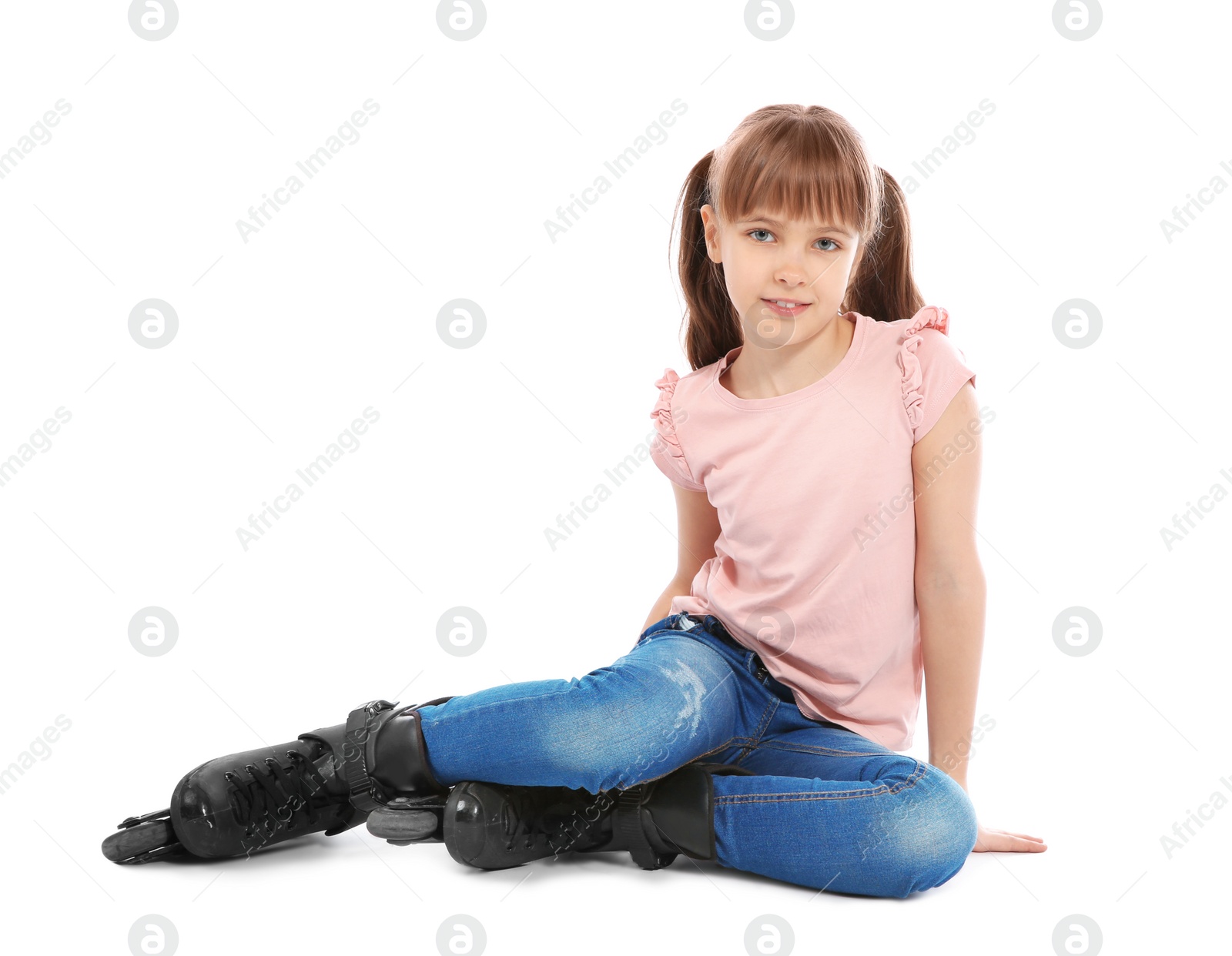 Photo of Girl with inline roller skates sitting on white background