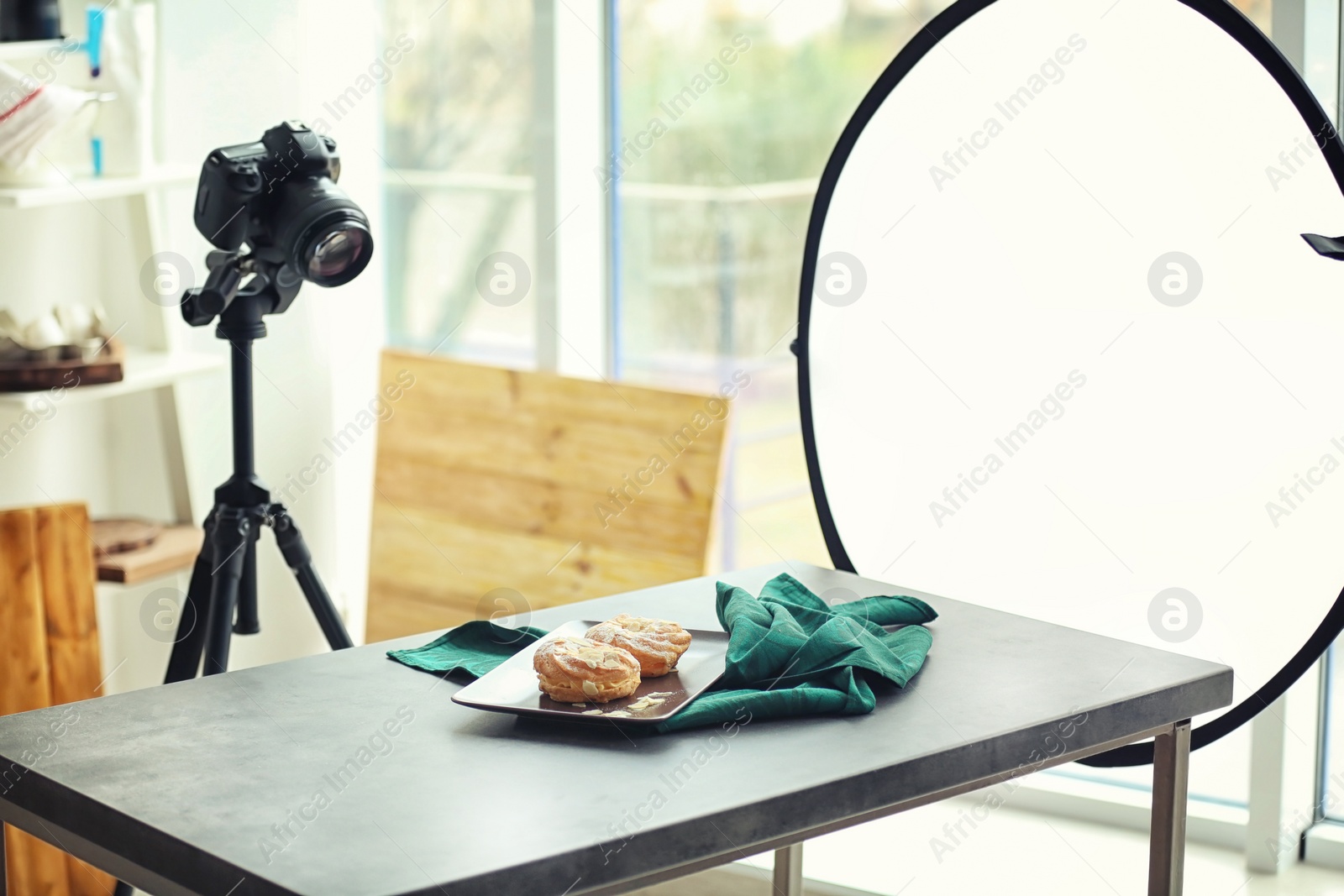 Photo of Professional camera on tripod and food composition in photo studio