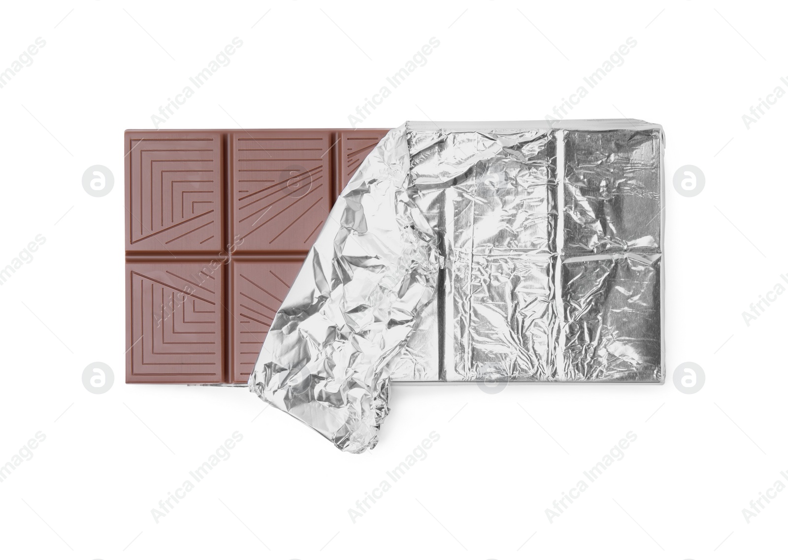 Photo of Delicious milk chocolate bar wrapped in foil isolated on white, top view