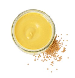 Photo of Glass jar of tasty mustard sauce and dry seeds isolated on white, top view
