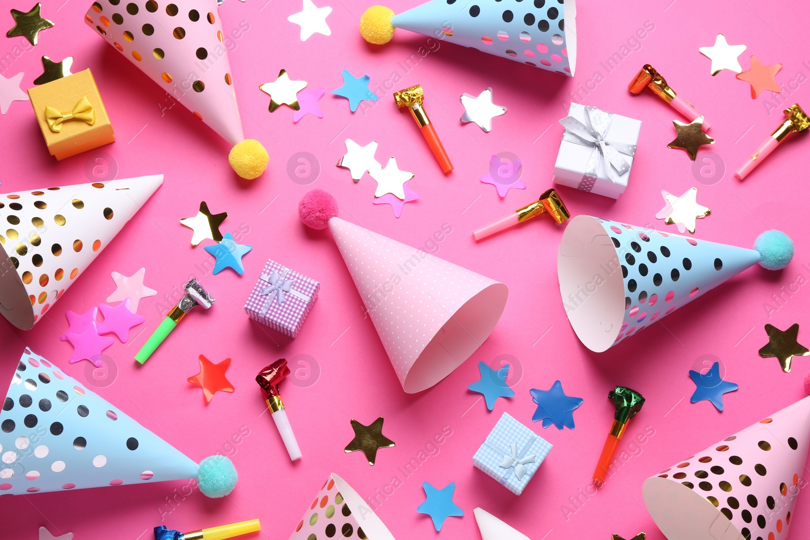 Photo of Flat lay composition with party hats on pink background