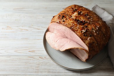Photo of Delicious baked ham on white wooden table. Space for text