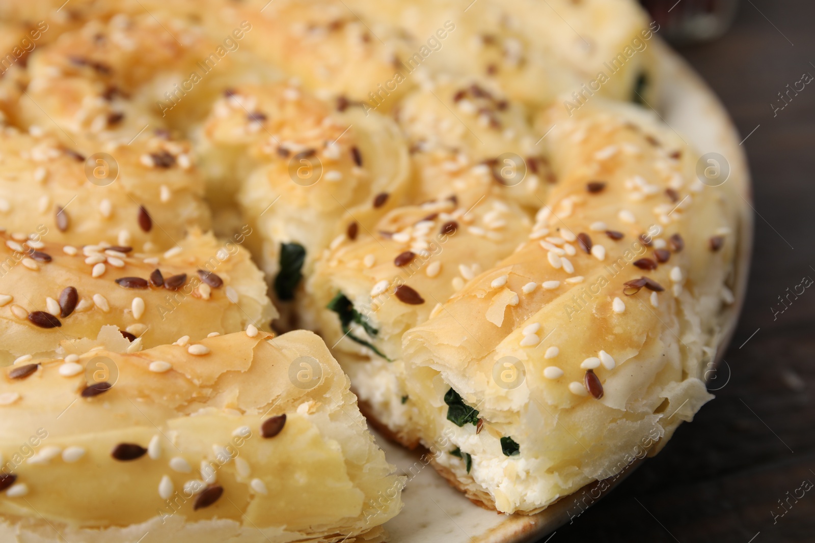 Photo of Delicious puff pastry with spinach on table, closeup