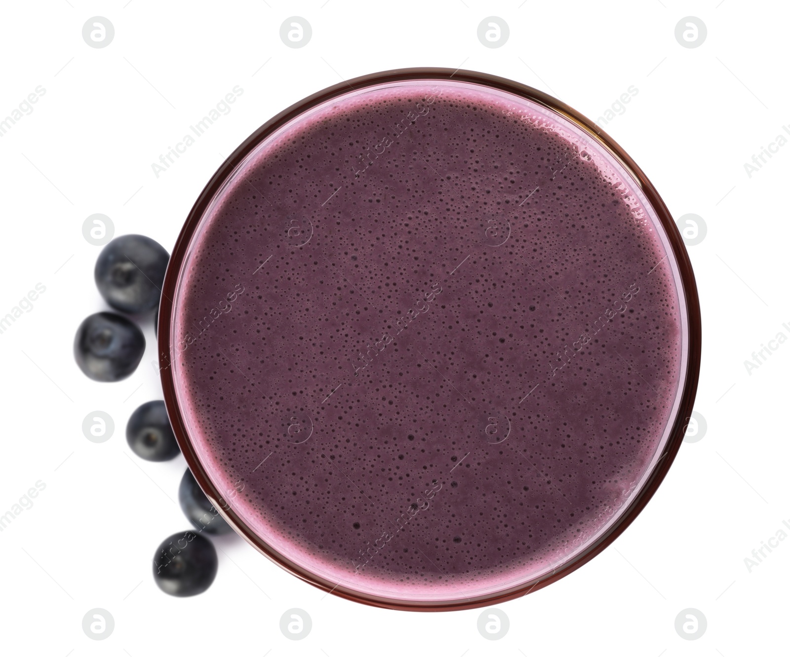 Photo of Glass of acai drink with berries on white background, top view