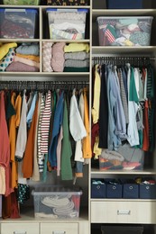 Wardrobe closet with different stylish clothes and home stuff. Fast fashion