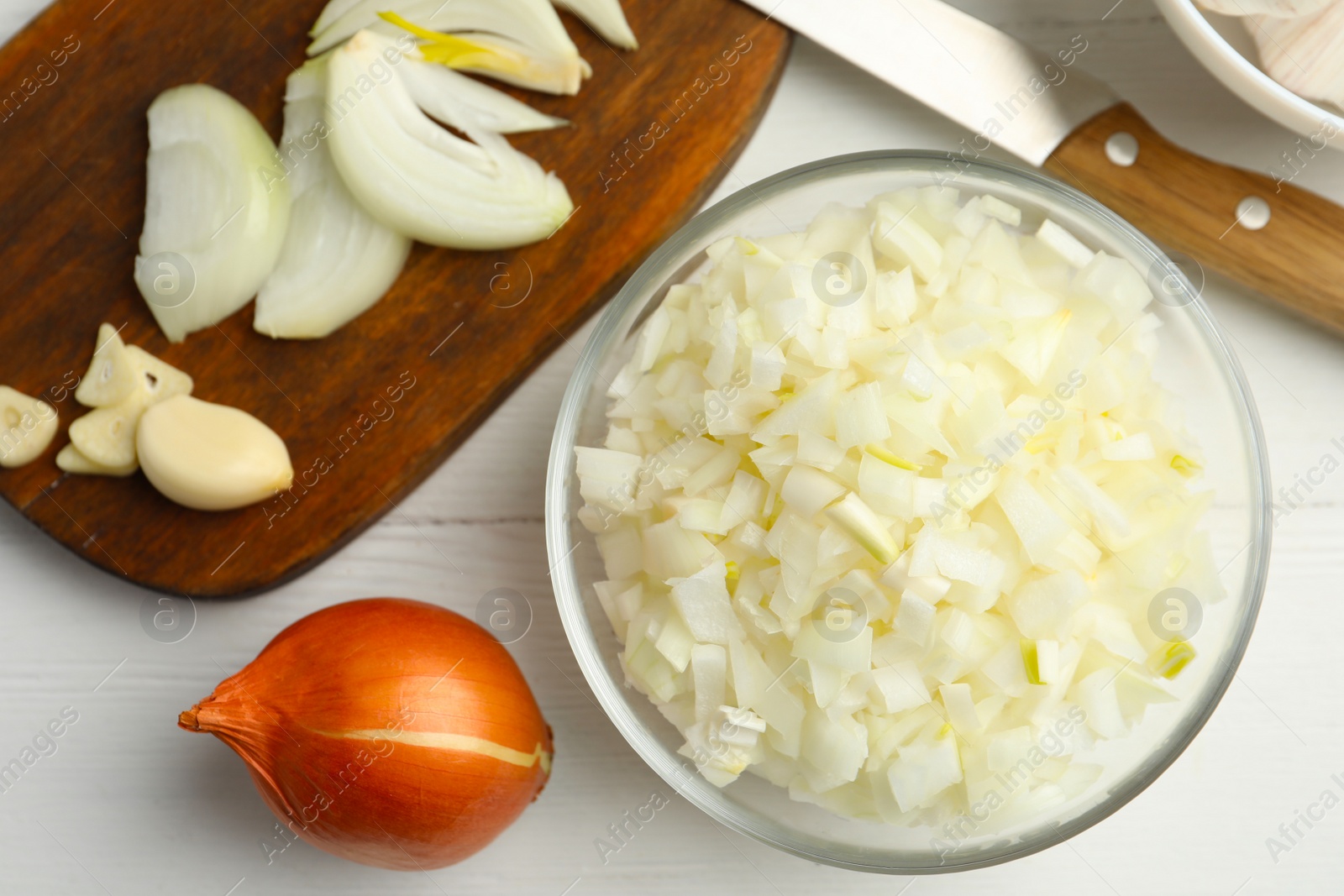 Photo of Flat lay composition with cut onion on white wooden table, flat lay