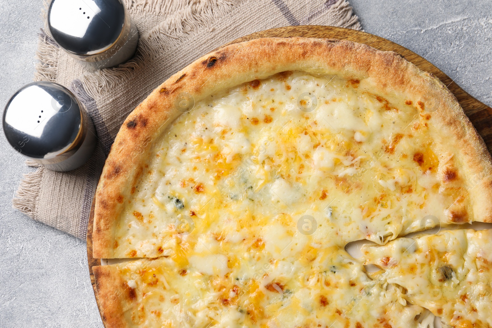 Photo of Delicious cheese pizza on light grey table, flat lay