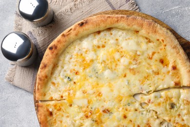 Delicious cheese pizza on light grey table, flat lay