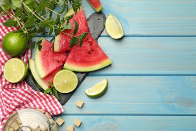 Photo of Cut tasty watermelon served with lime, mint and sugar on light blue wooden table, flat lay. Space for text