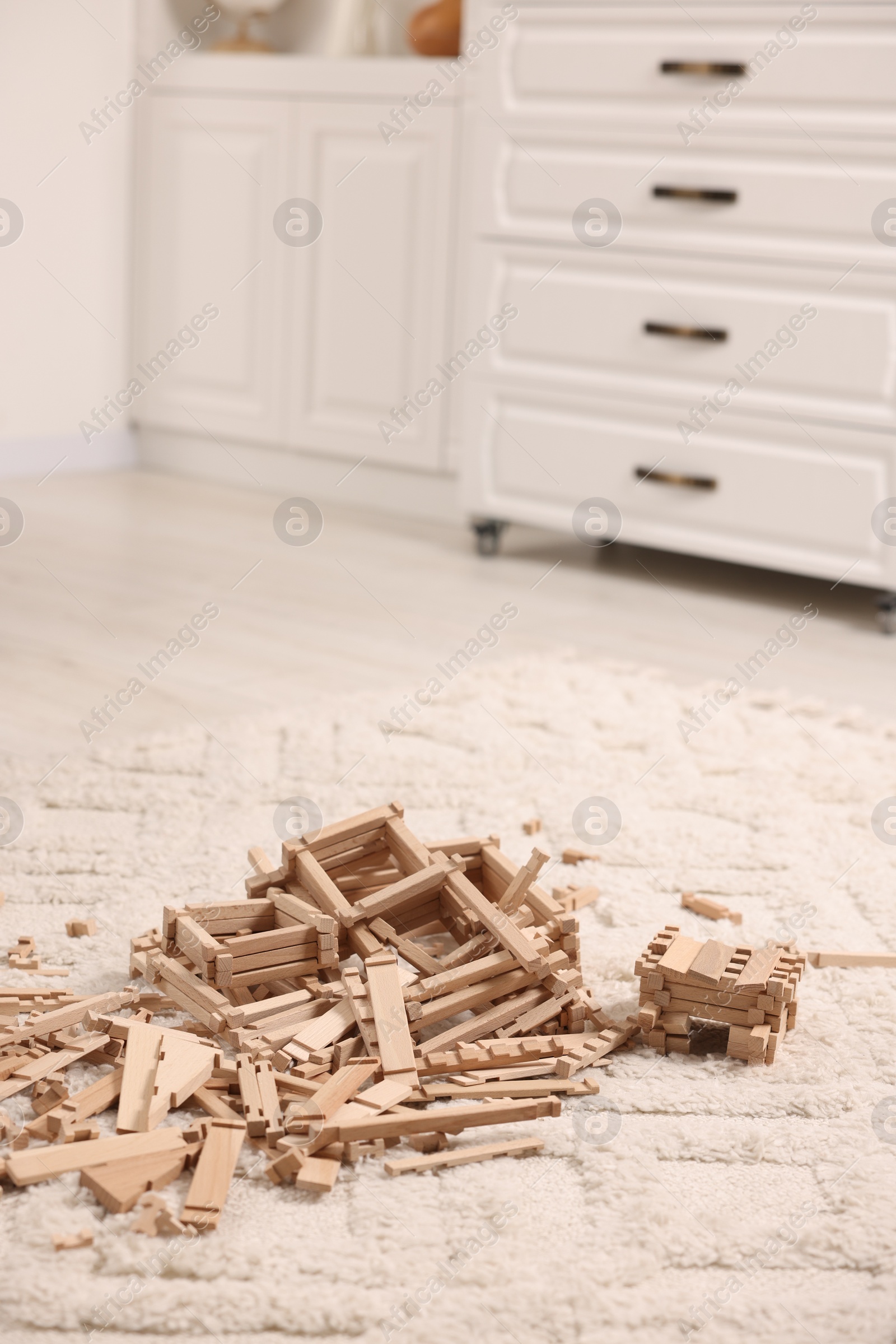 Photo of Wooden construction set on carpet indoors. Children's toy