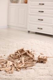 Wooden construction set on carpet indoors. Children's toy