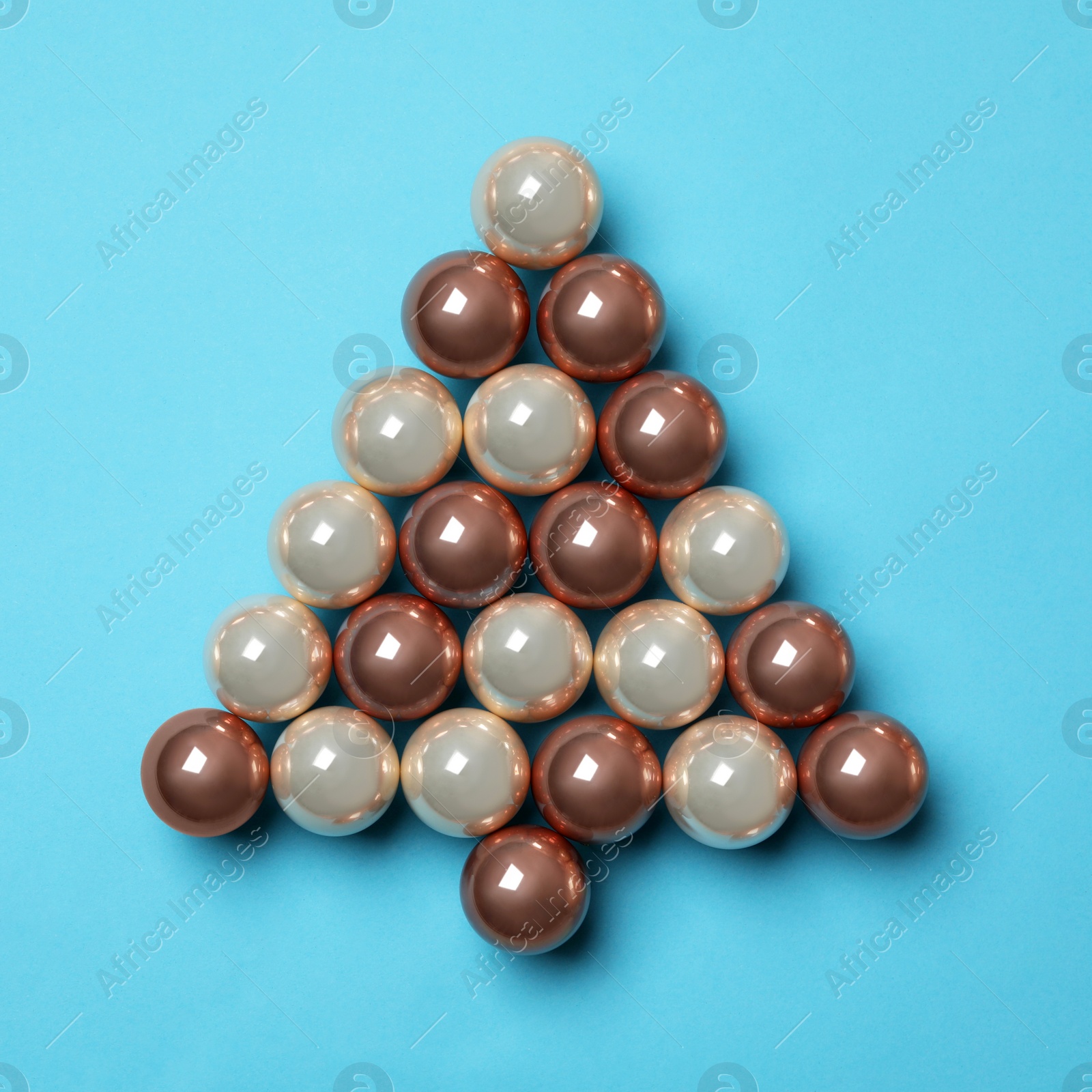 Photo of Christmas tree made of decorations on blue background, top view. Space for text