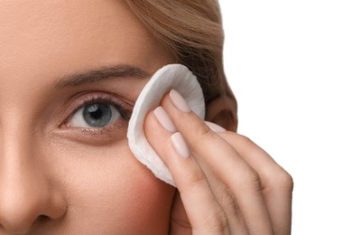 Photo of Woman removing makeup with cotton pad on white background, closeup