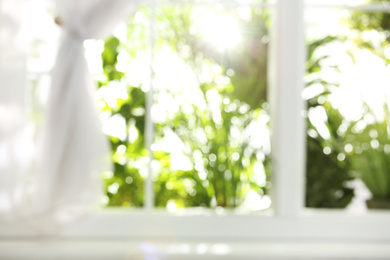 Photo of Blurred view through window on garden in morning