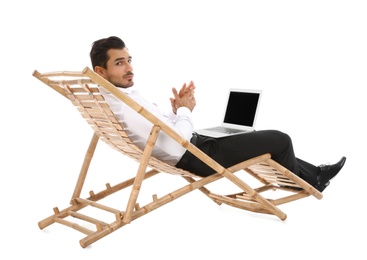 Photo of Young businessman with laptop on sun lounger against white background. Beach accessory