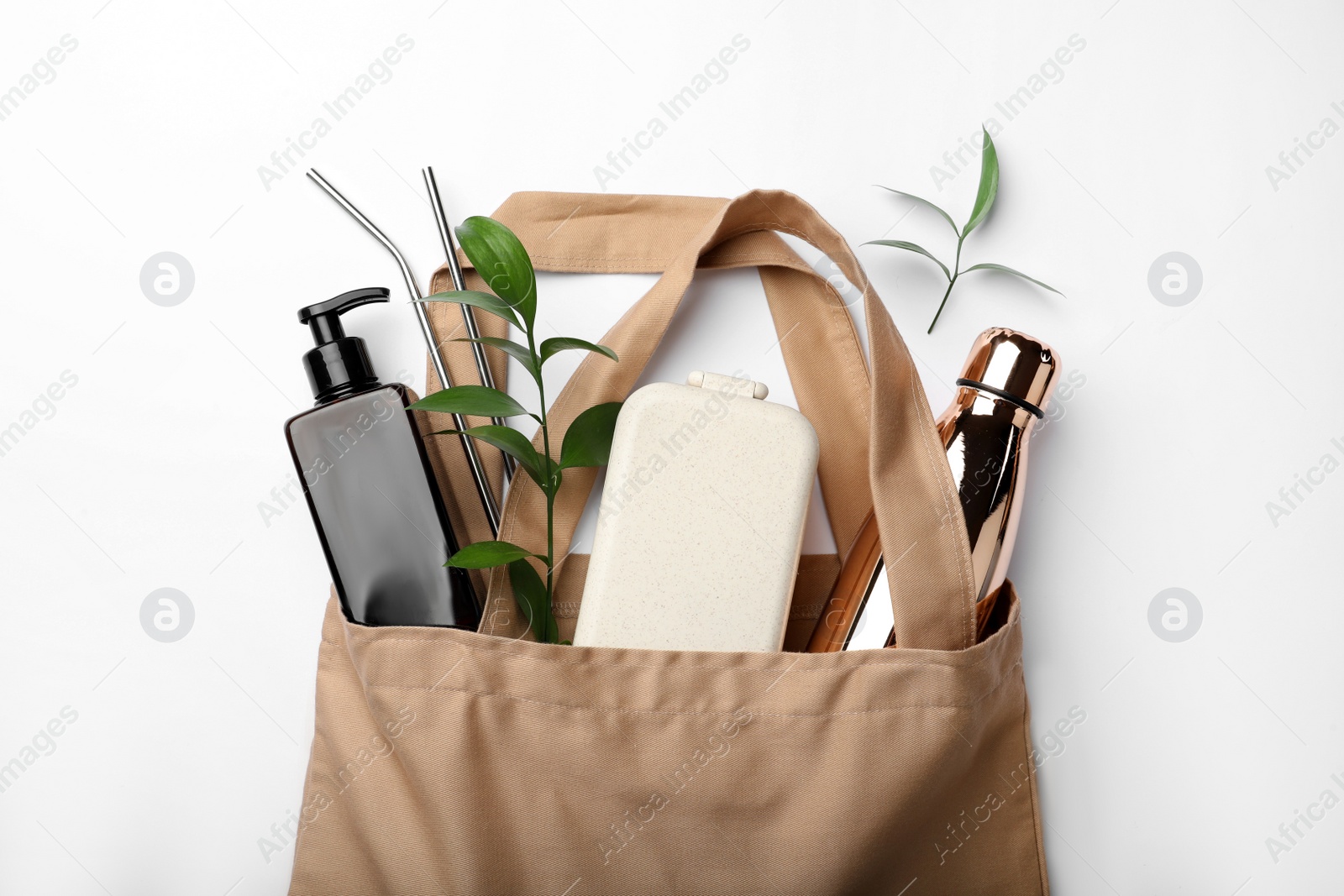 Photo of Bag with eco friendly products on white background, top view