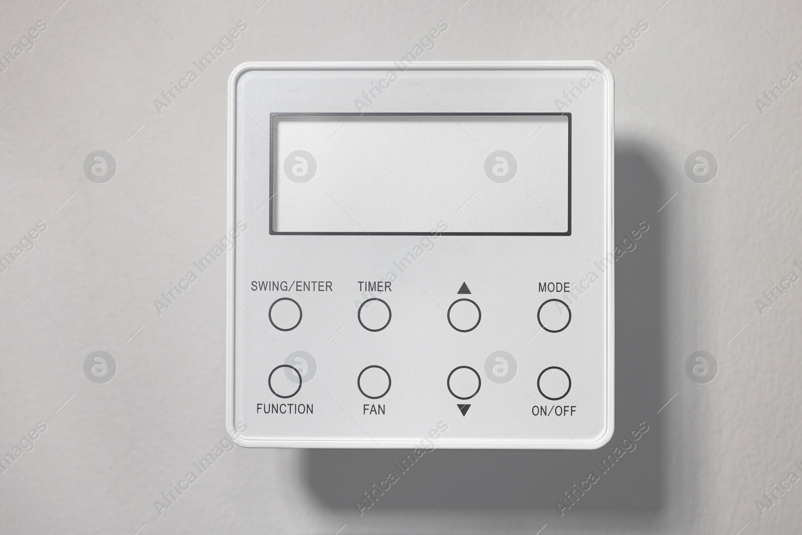 Photo of One thermostat on white wall. Smart home system