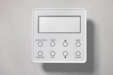 Photo of One thermostat on white wall. Smart home system