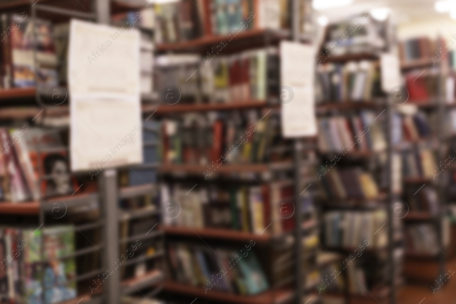 Photo of Blurred view of shelving units with books in library